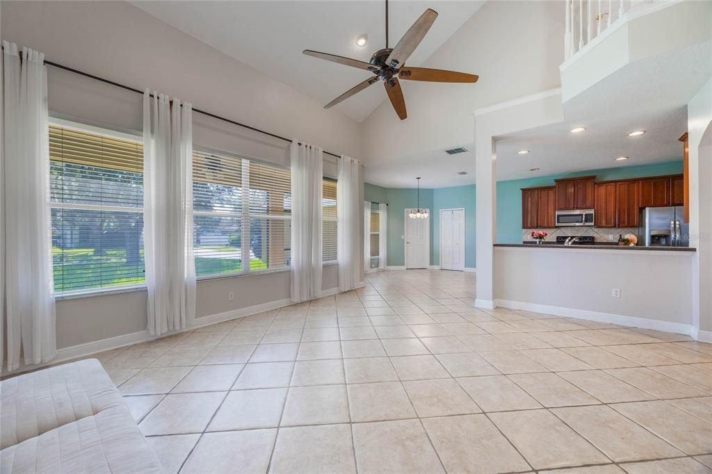 Great room with cathedral ceiling with view of kitchen area.