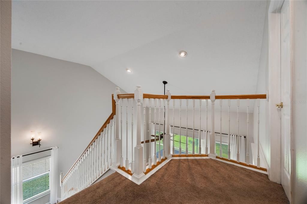 Open staircase leads to upstairs bedrooms and bonus space.