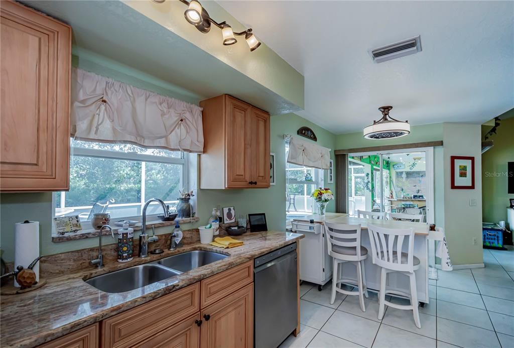 Dining area off of kitchen with another great window space and sliding doors to patio.