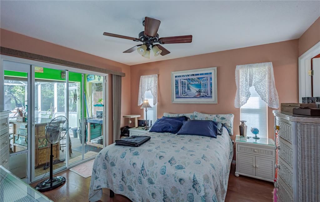 Master bedroom with sliding glass doors onto the pool area!  Side windows add extra light to this delightful  room.