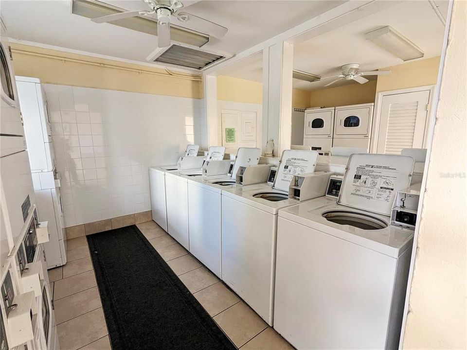 SPACIOUS multi-machine coin laundry, located next to pool & office