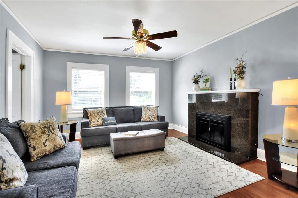 Natural light and  gas fireplace make for a cozy room to relax and visit with friends and family