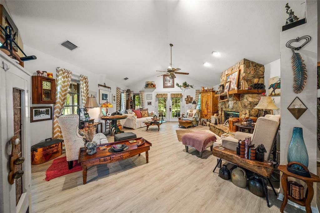 Expansive Great Room with double-sided stone fireplace.