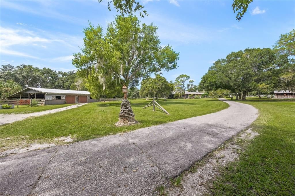 Long winding driveway past the barn to the main house.