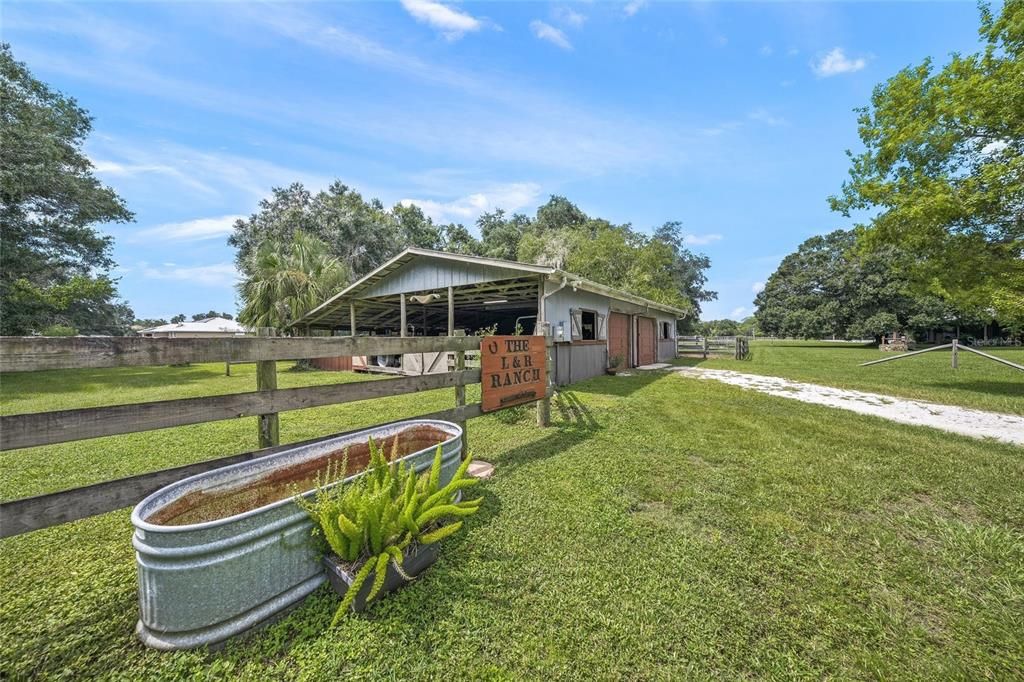 Oversized Barn w/ Feed Room and Tack Room plus 3 stalls, but it could accommodate 7 stalls.