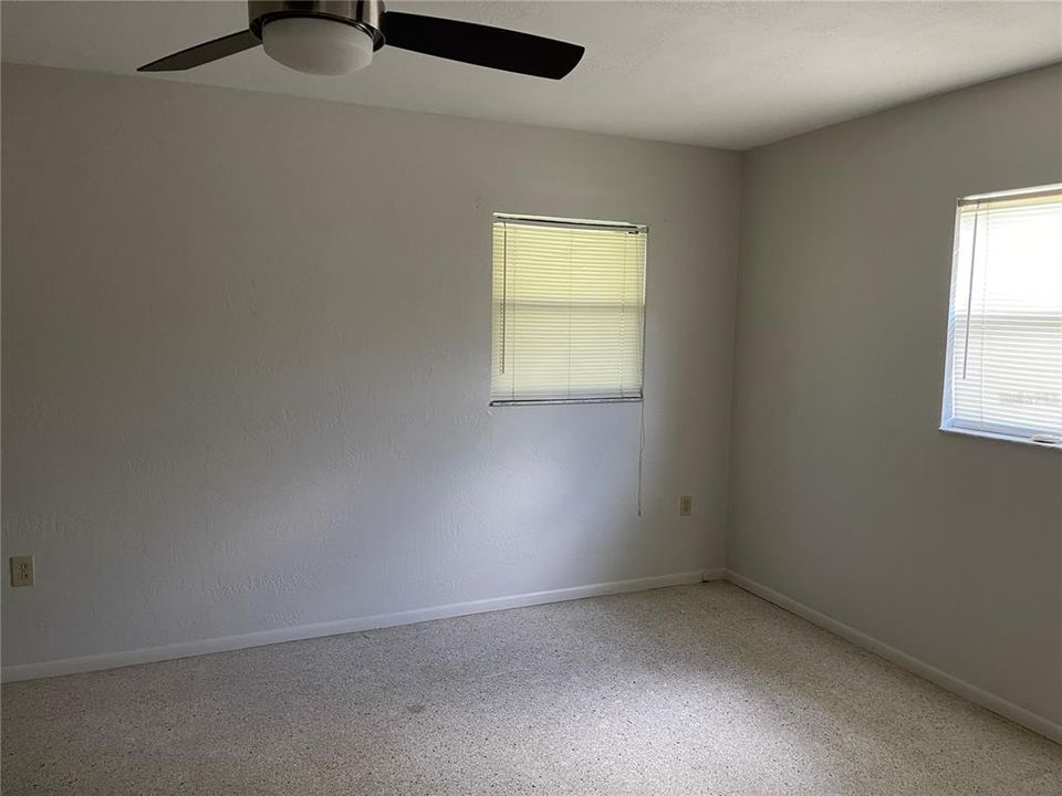 Another bedroom with a ceiling fan.