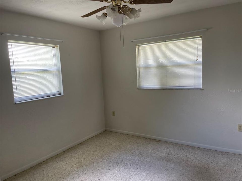 One bedroom with a ceiling fan.