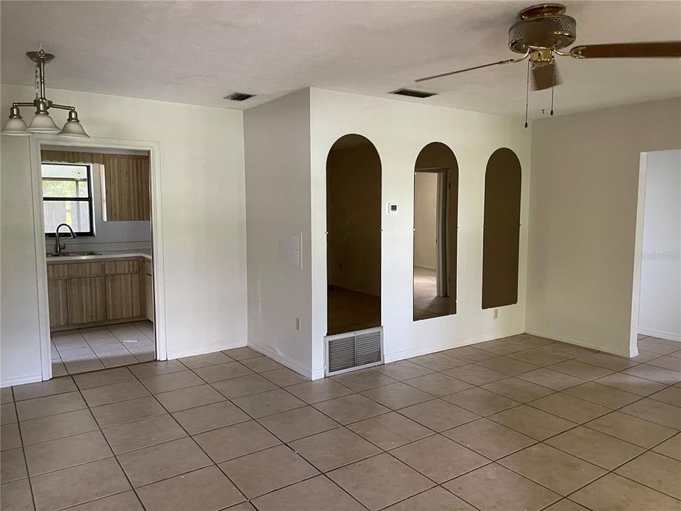 The great room boasts a ceiling fan and there's space for a dining table.