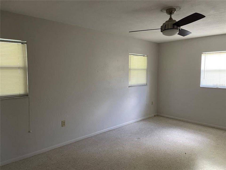 The bedroom and the rest of the home feature tile flooring.