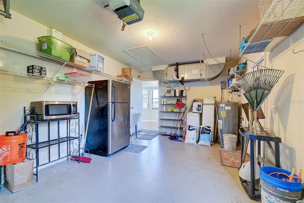 The garage is equipped with an electric garage door opener and a laundry tub.