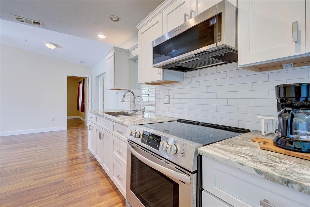 The kitchen is accented with tasteful subway tile as a backsplash.  It is easy to care for.