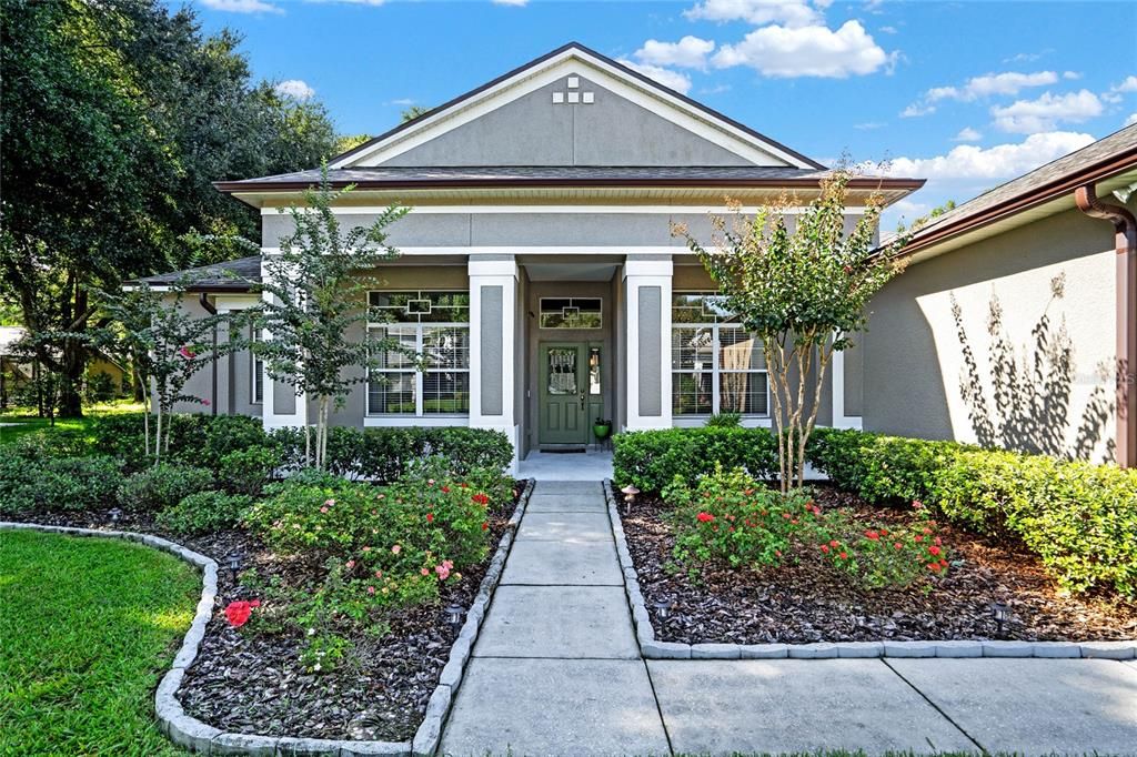 Rose bushes and crepe myrtles provide a warm welcome.