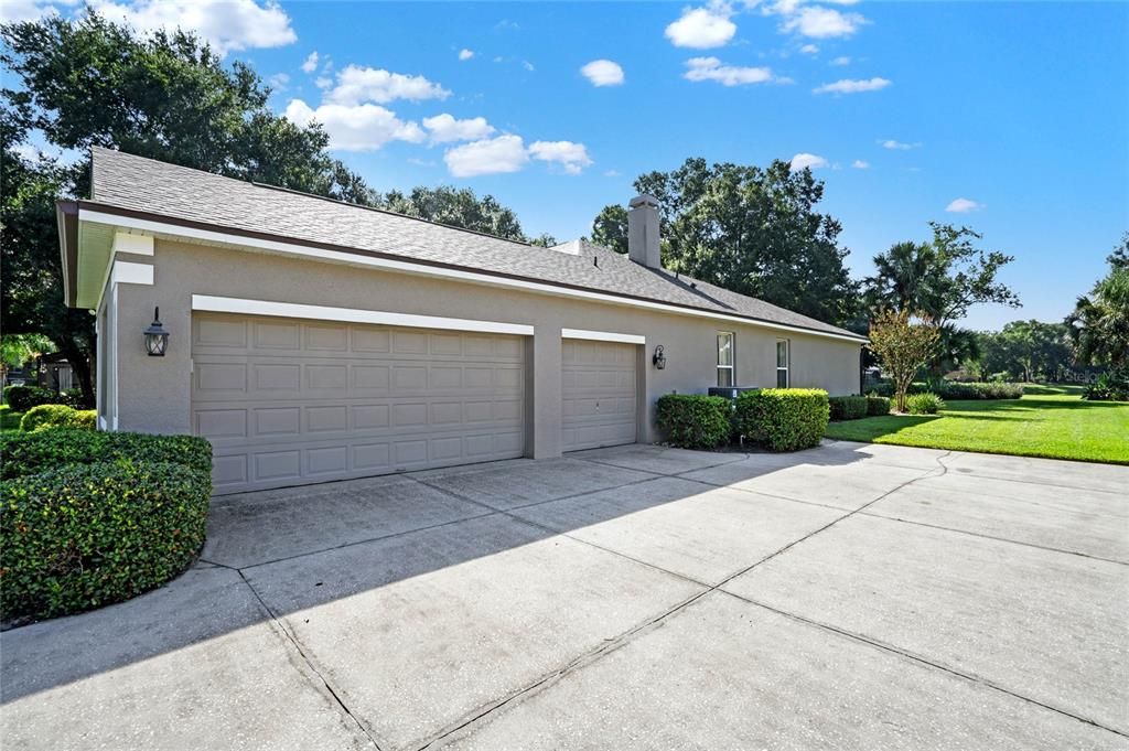 Three car garage with additional space for 6+ cars in driveway.