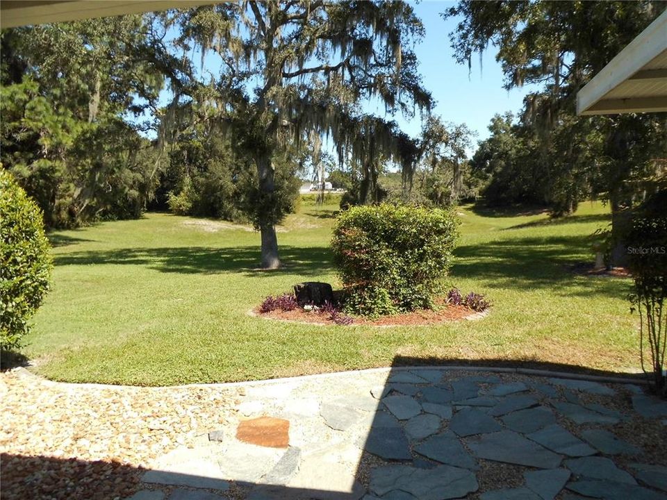 VIEW OF BACKYARD FROM COVERED PATIO