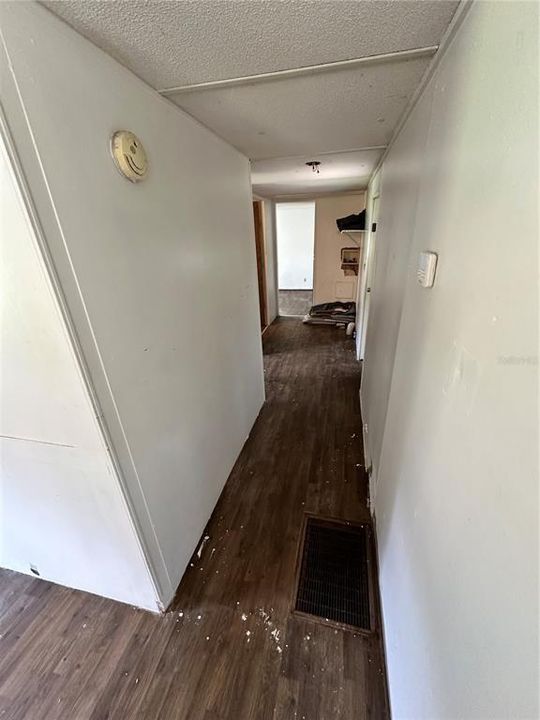 Looking down the hall from the living room. Washer and dryer hookups at the end.