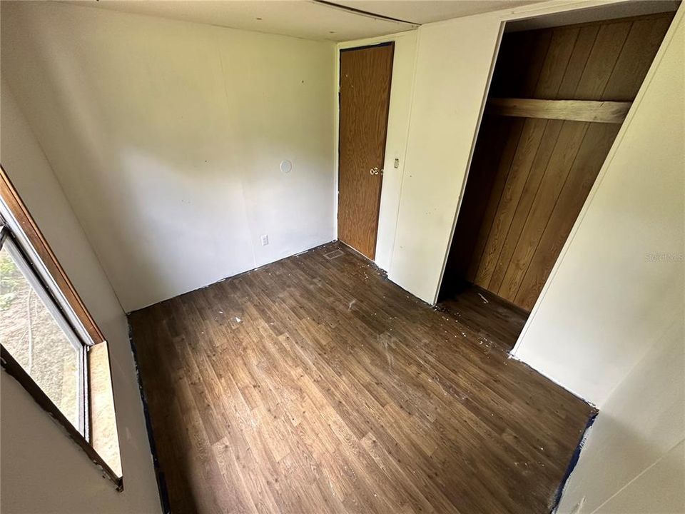 Bedroom 1 looking at the closet and entry door.