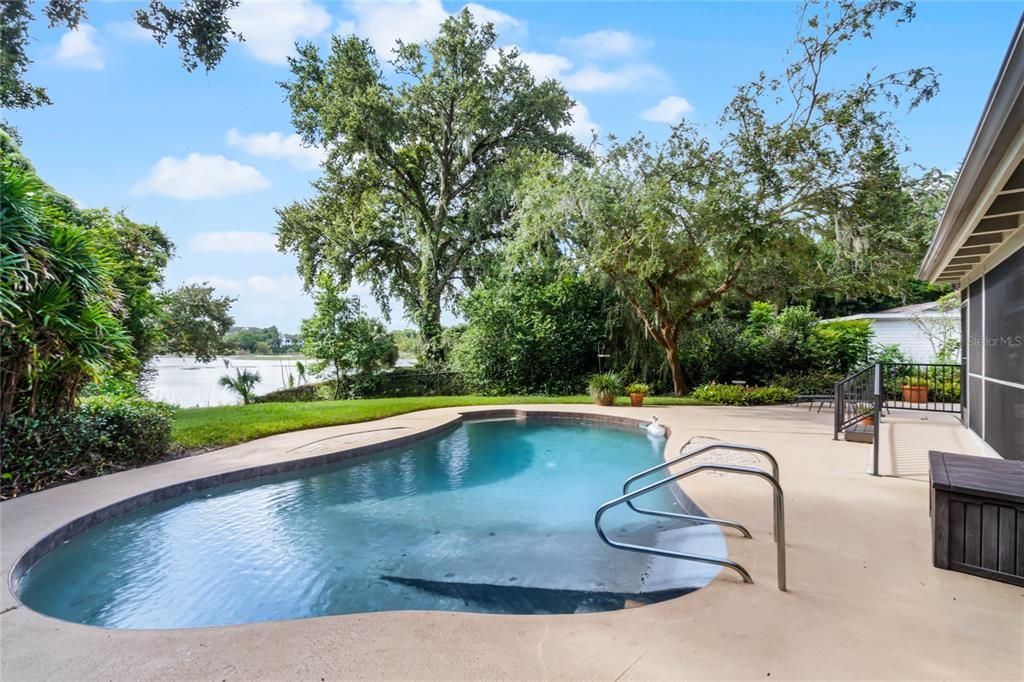 Inviting swimming pool with incredible views of lushly landscaped backyard