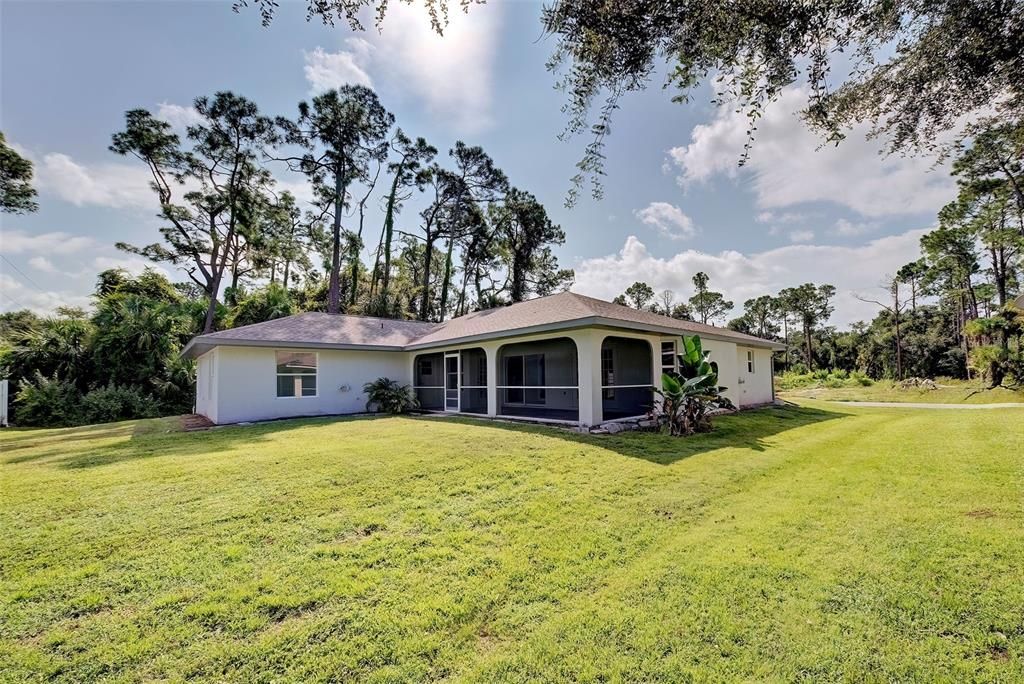 GREAT YARD AND LARGE COVERED SCREENED PORCH UNDER ROOF!