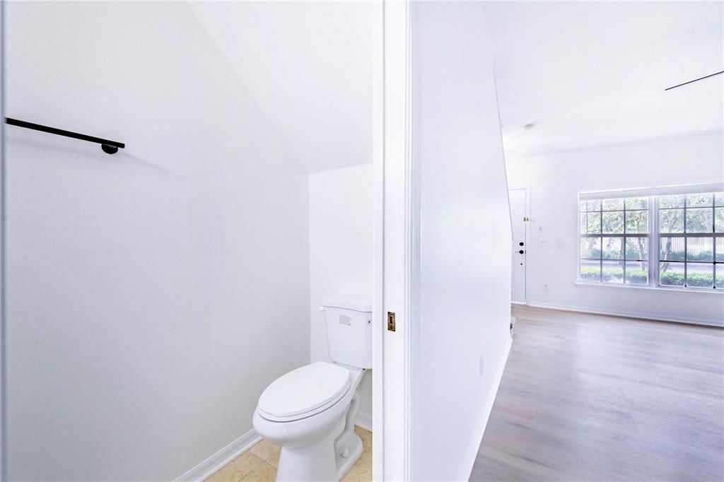 Powder room located downstairs near kitchen and family room areas