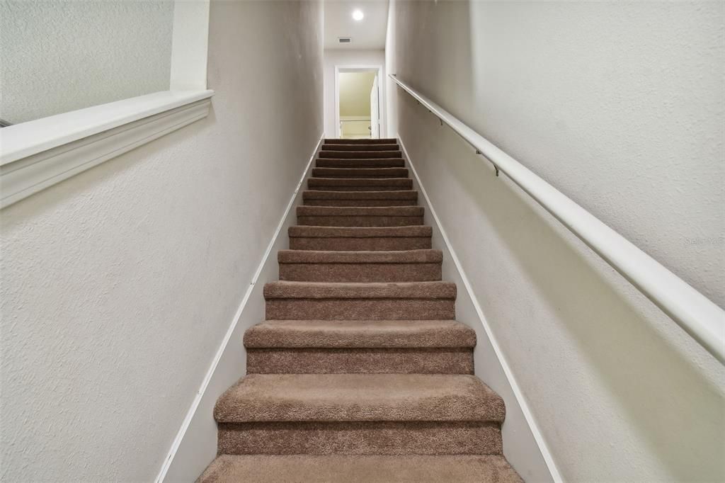 Steps with coat closet at the bottom