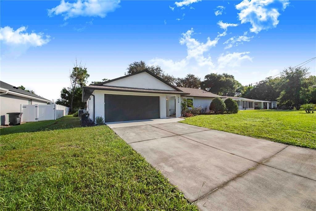 2 car garage with laundry feature, front covered porch and extra long driveway for guest parking