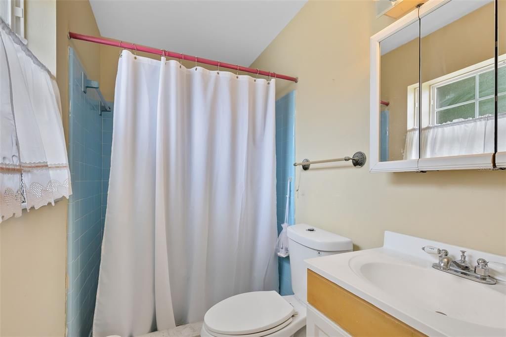 Your en suite bath features a shower with delightful powder blue retro tile.