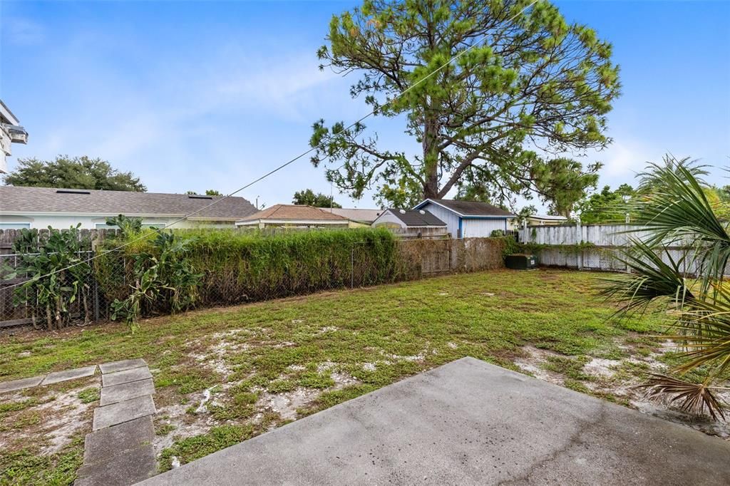 Your patio looks over your large, fenced backyard.