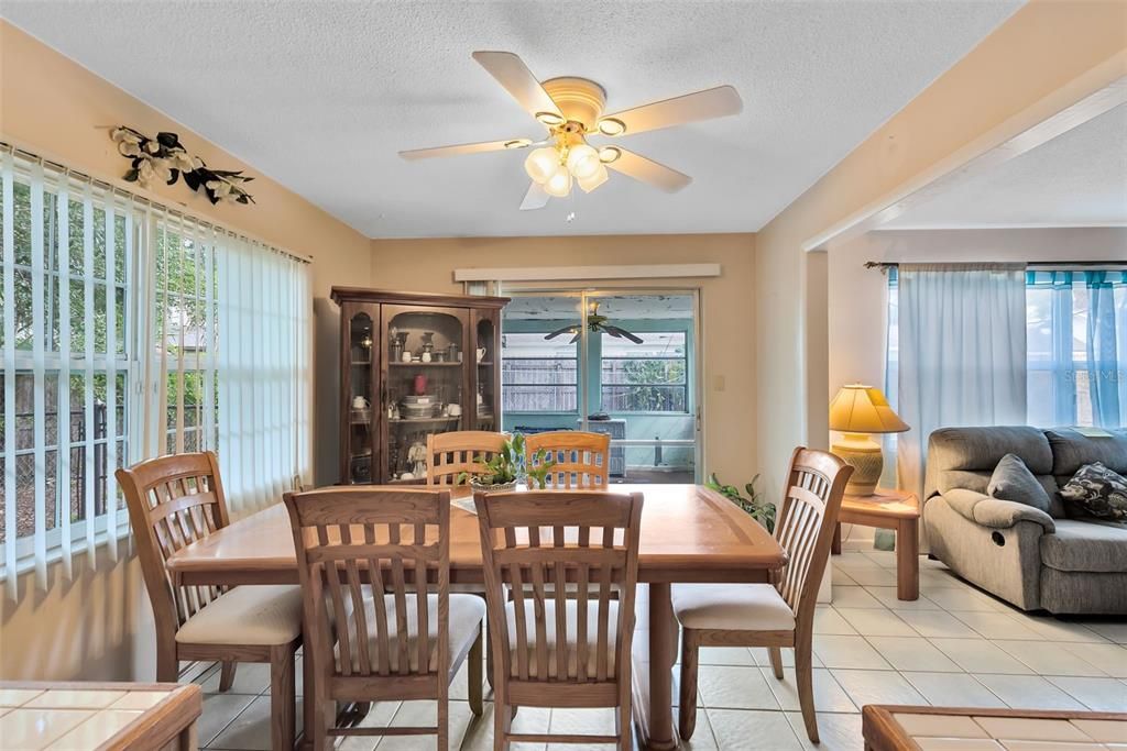 Adjacent to the kitchen, the dining area has sliding glass doors that lead into a spacious Florida room.