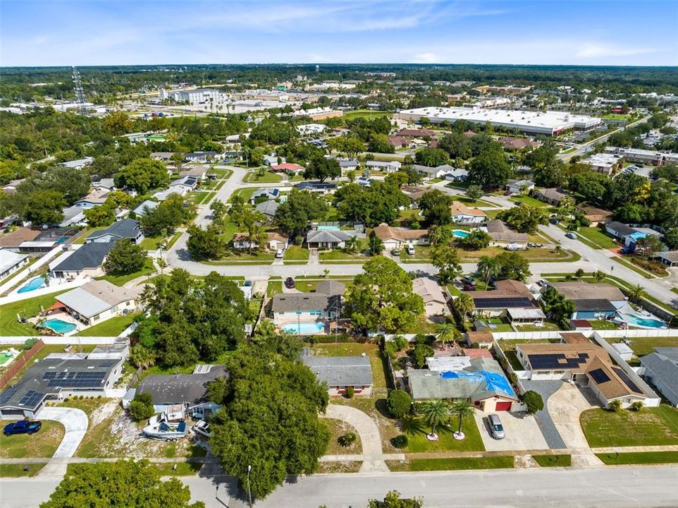 Aerial view of the front of the home and surrounding neighborhood.