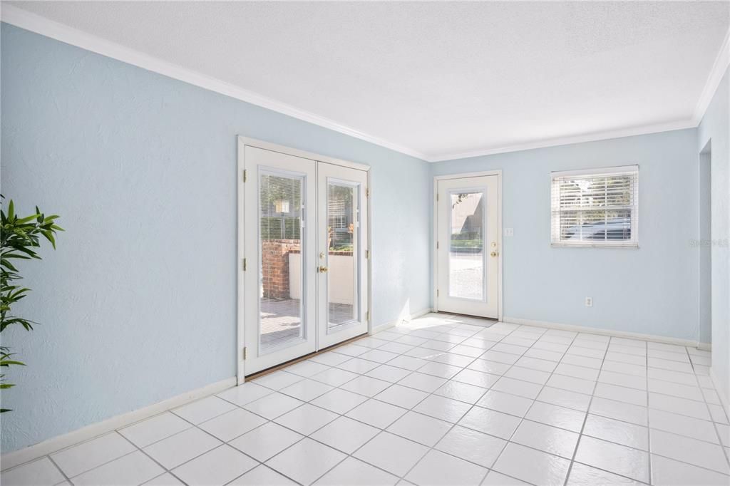 French doors lead out to patio space. Blinds built in the doors.