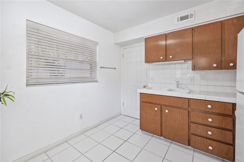 Laundry room through door on the left.