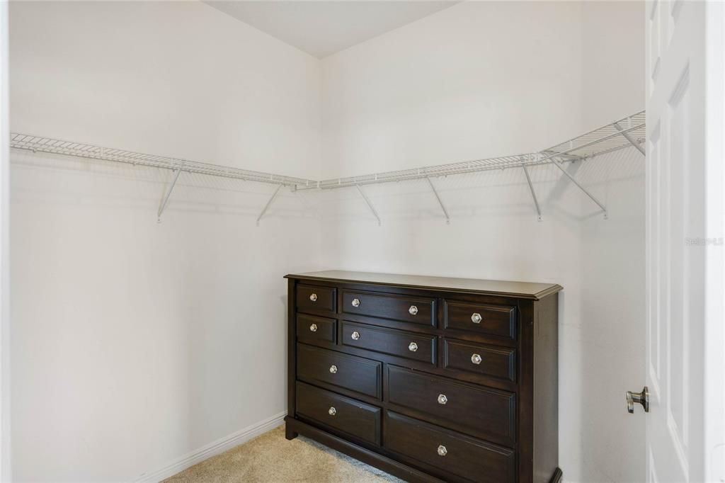 Primary bedroom walk in closet