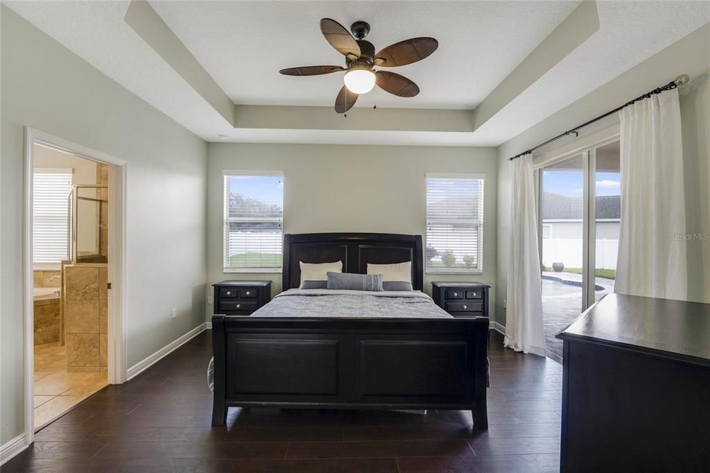 Primary bedroom with wood like floors