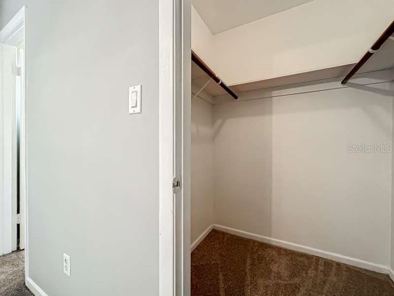 Primary bedroom walk-in closet