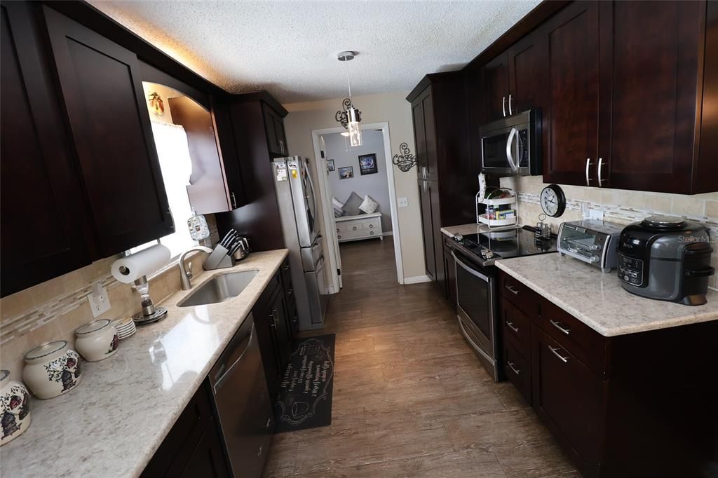 Beautiful 42" Cherry cabinets with quartz counters & ss appliances