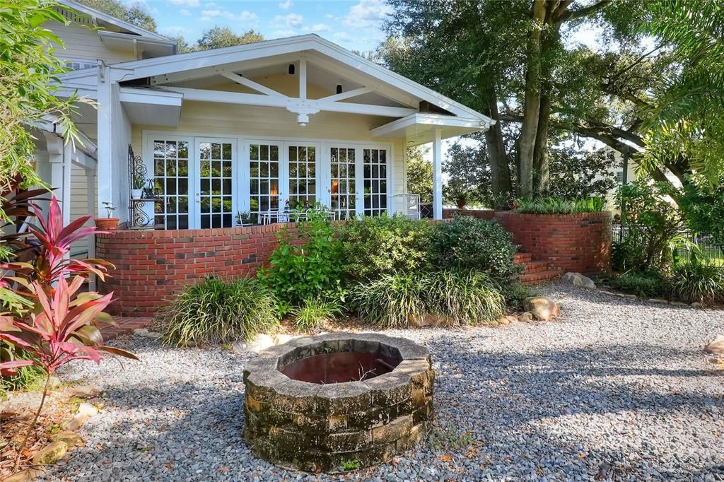 Rear view of house and garden with fire pit.