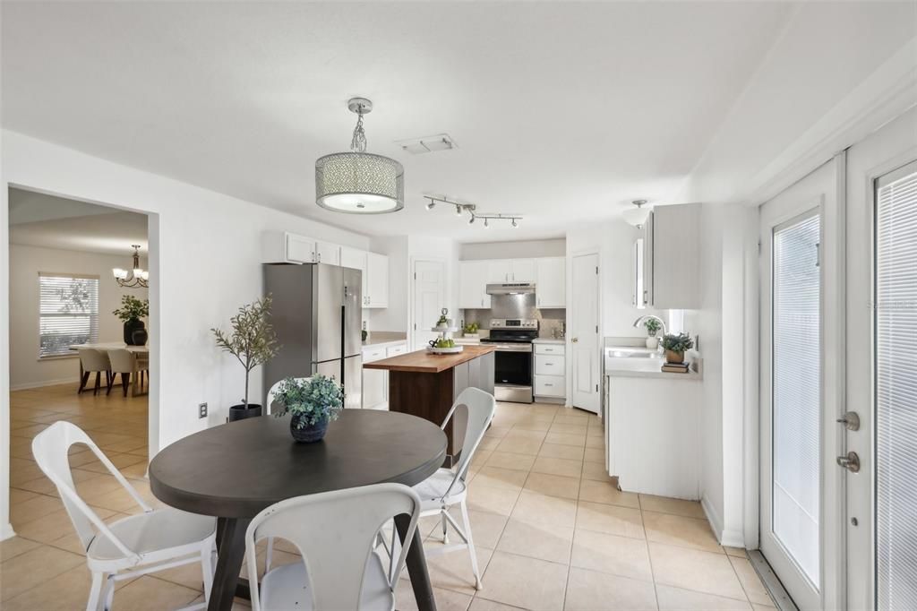 Dinette and double French Doors with interior blinds to the backyard.