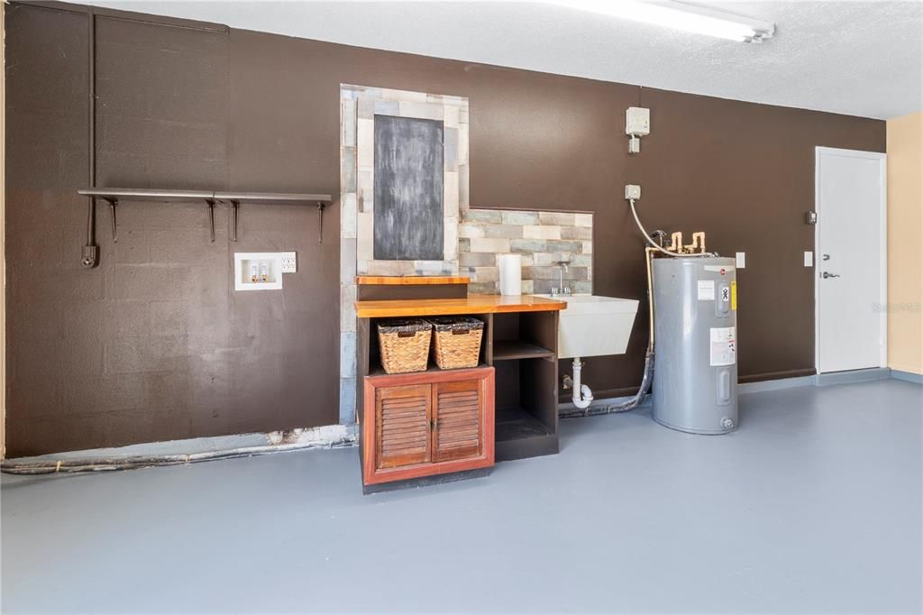 Garage with Washer/Dryer Hook-ups and Laundry Station and Water Heater