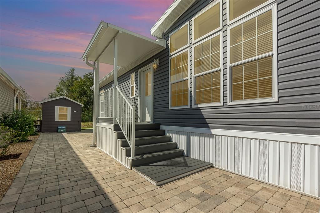 Front porch and cover with composite wood stairs added Nov. 2022