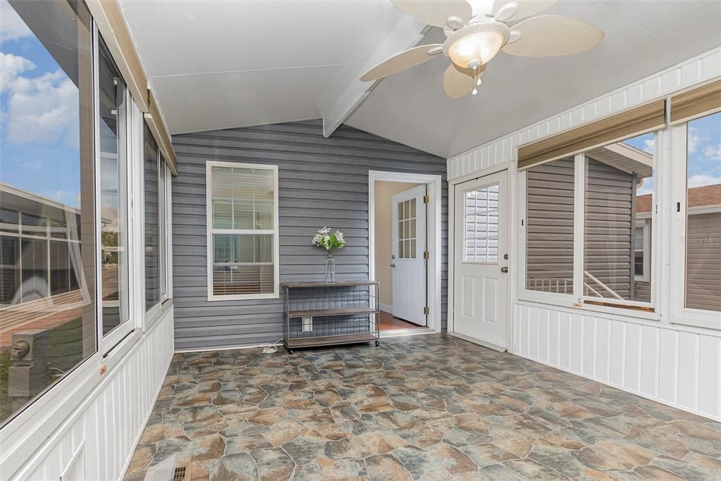 Gorgeous vaulted sunroom with sliding windows and drop down shades throughout