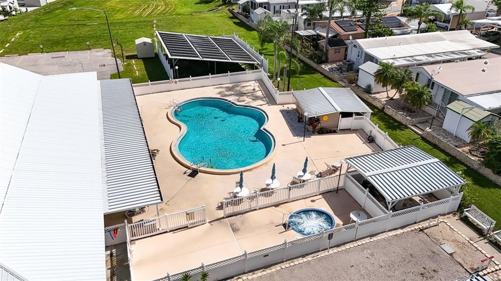 Private heated pool with covered sitting area and hot tub