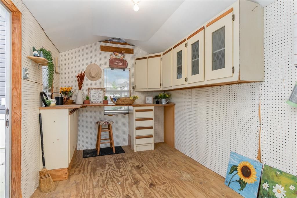 Shed features full walls of pegboard, cabinets, drawers and spacious work counter. Electric and water also available.