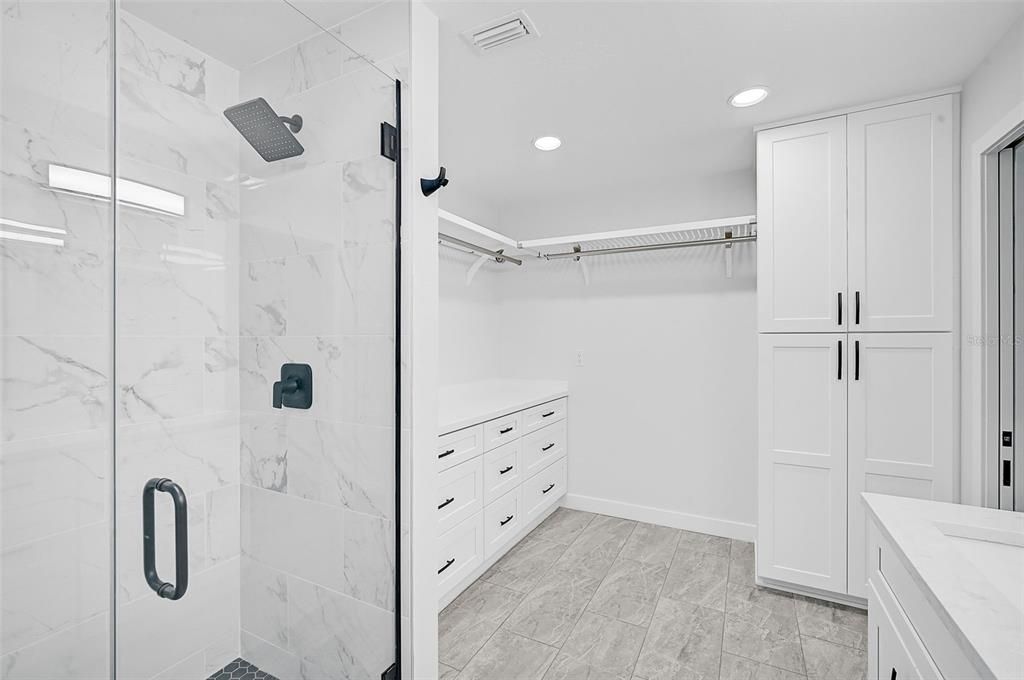 Built-in closet in the master bathroom-great drawer spaces and hanging space as well