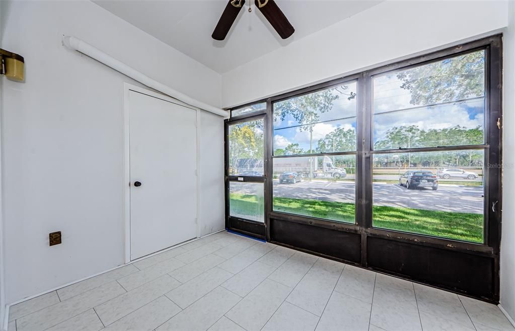 Screen and covered Lanai with ceiling fan and storage closet, along with new ceramic tile.