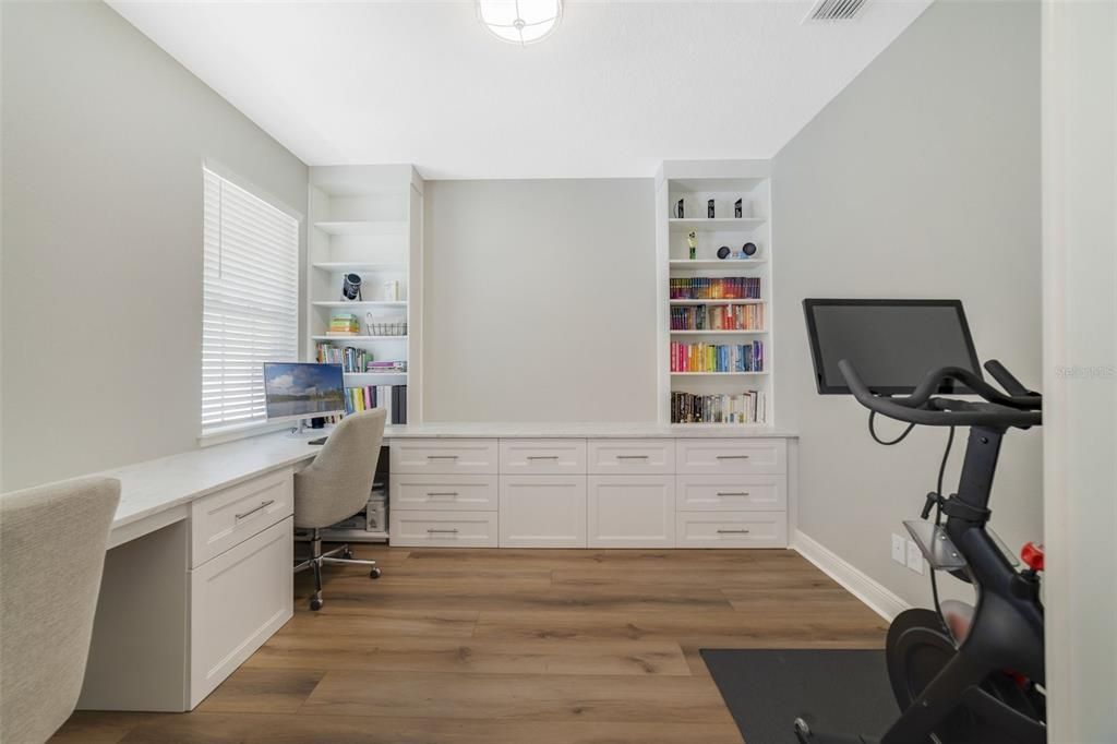 Behind double doors a dedicated office/flex space awaits with new luxury vinyl plank flooring and CUSTOM BUILT-INS to suit a variety of needs.