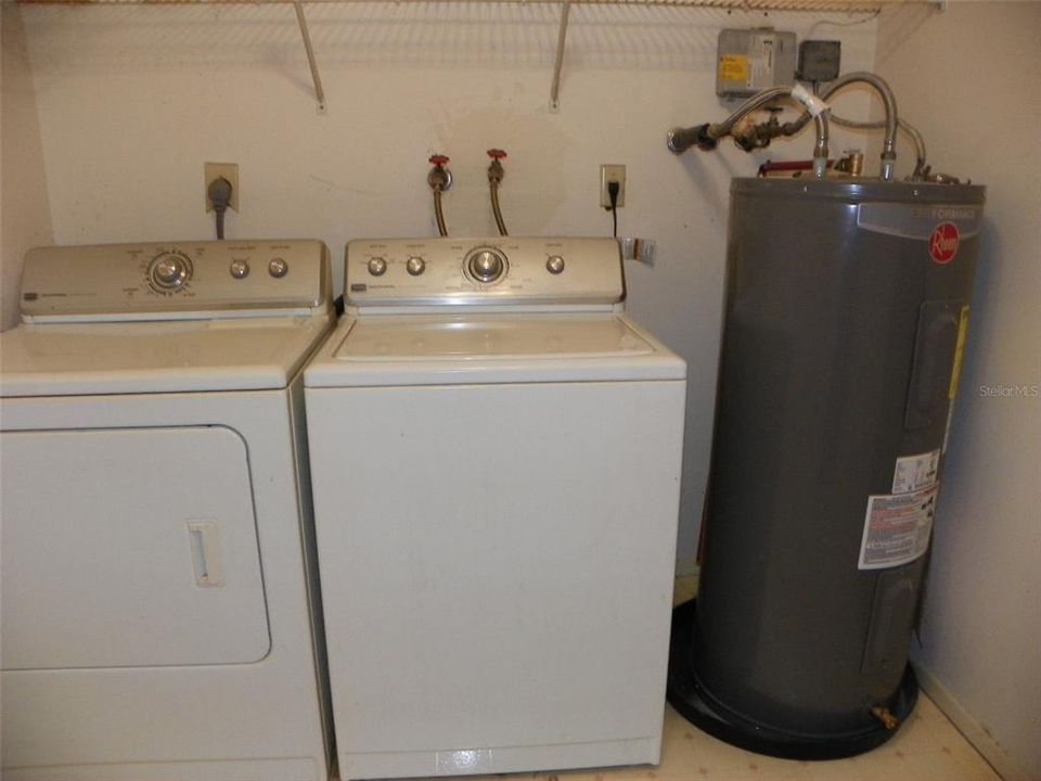 Washer, Dryer, Hot Water Heater in utility room.