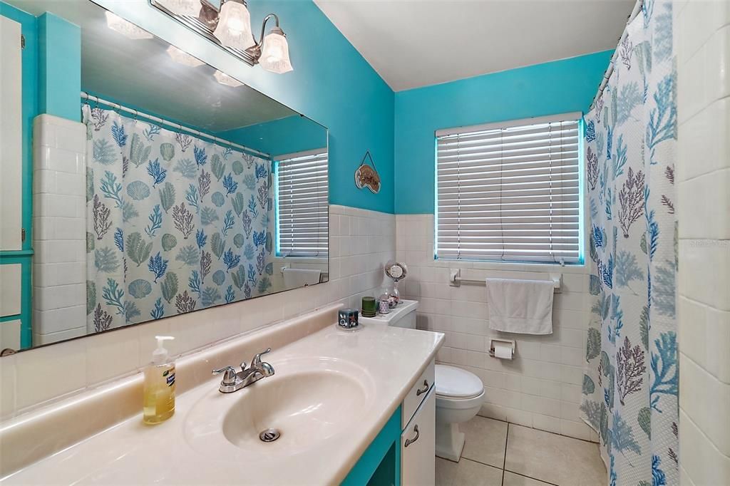 Bathroom features a tub with shower combo