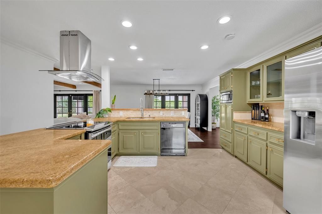 Lovely green cabinetry in spacious kitchen