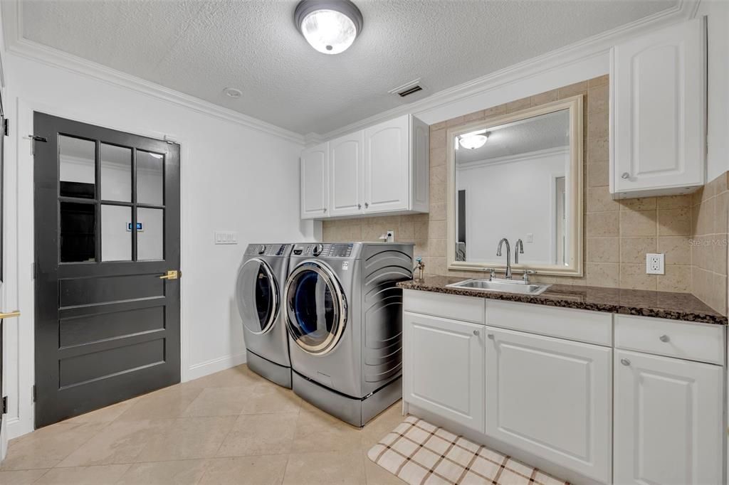 Spacious laundry room leading to your updated garage