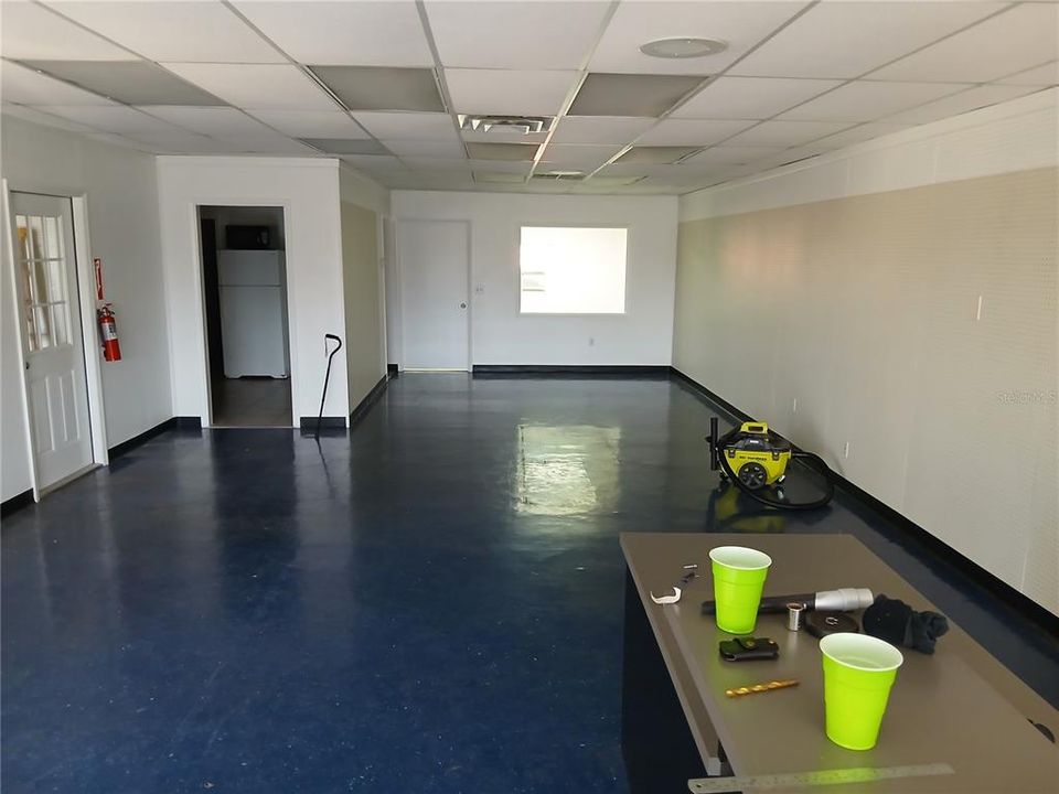 office area looking toward rear private office in rear door to left break roon and bath